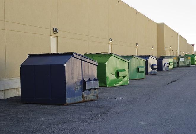 a group of dumpsters lined up along the street ready for use in a large-scale construction project in Clarksville FL